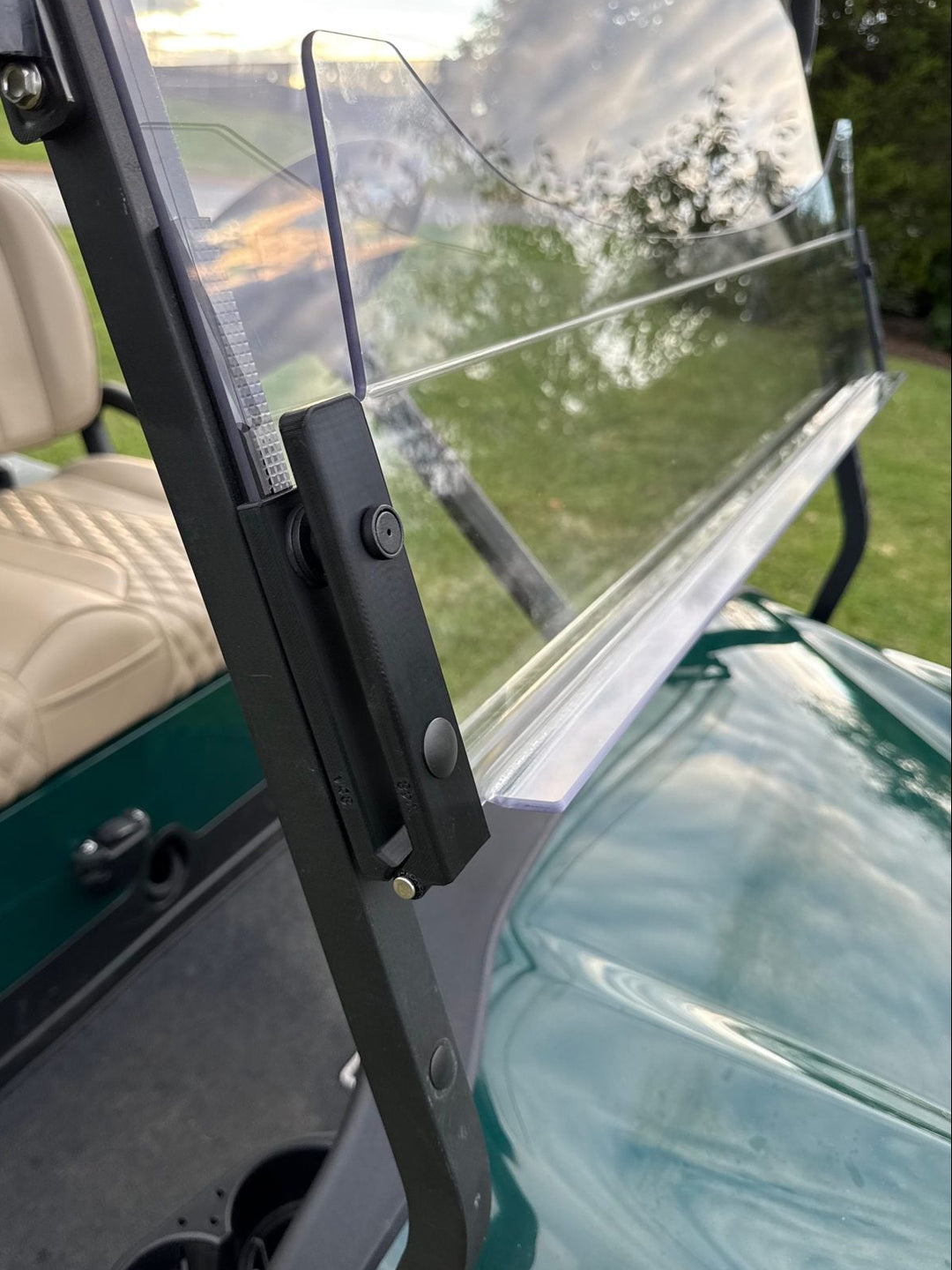 Evolution pivot hinge with the lower panel flipped out for airflow on a Club Car Onward